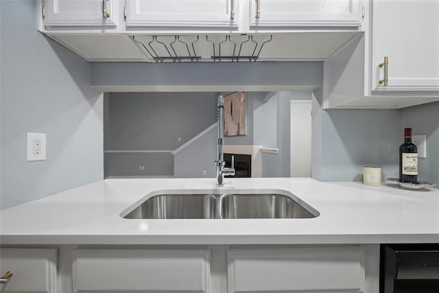 kitchen featuring sink and white cabinetry