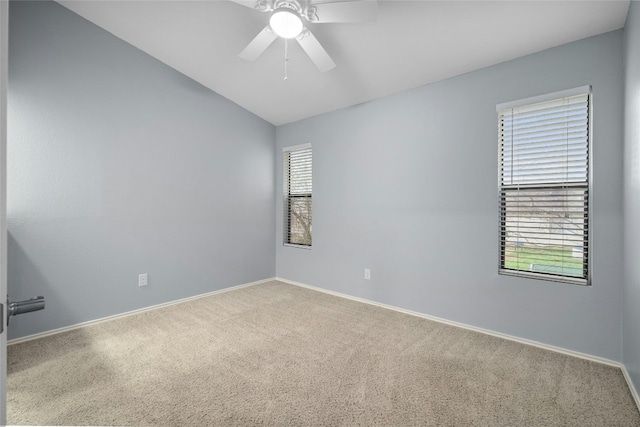 carpeted spare room with ceiling fan and lofted ceiling