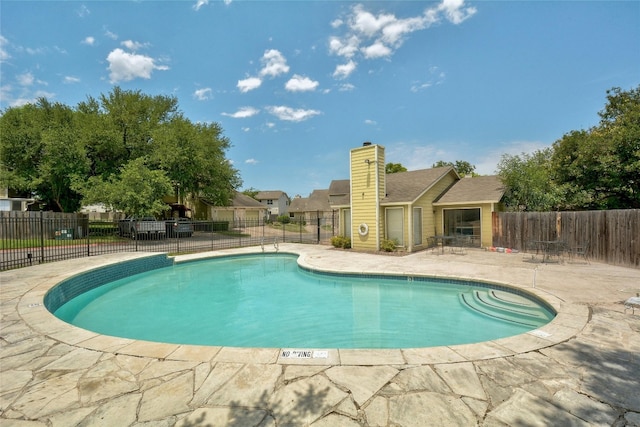 view of swimming pool featuring a patio area