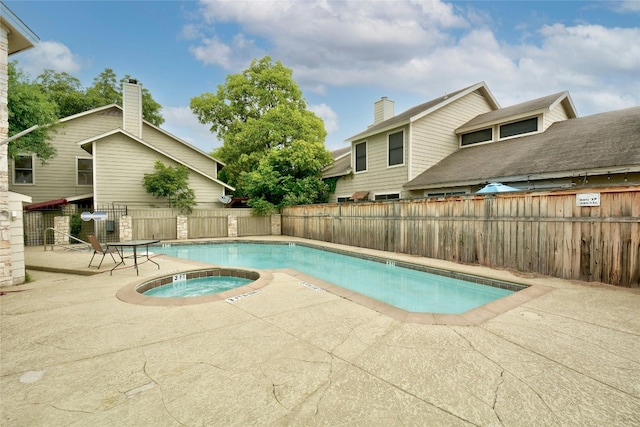 view of pool featuring a community hot tub and a patio