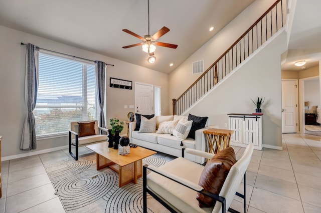 living room with high vaulted ceiling, light tile patterned floors, and ceiling fan