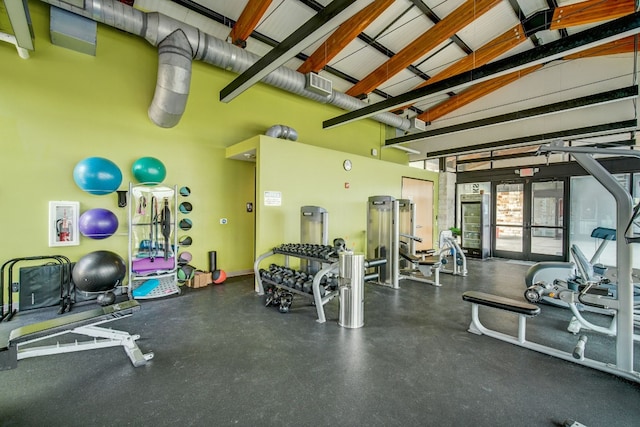 gym featuring french doors and high vaulted ceiling