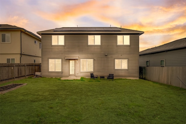 back house at dusk with a yard