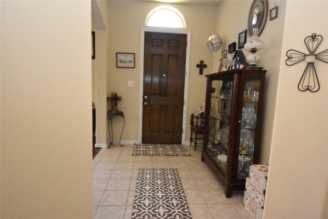 entryway with light tile patterned flooring