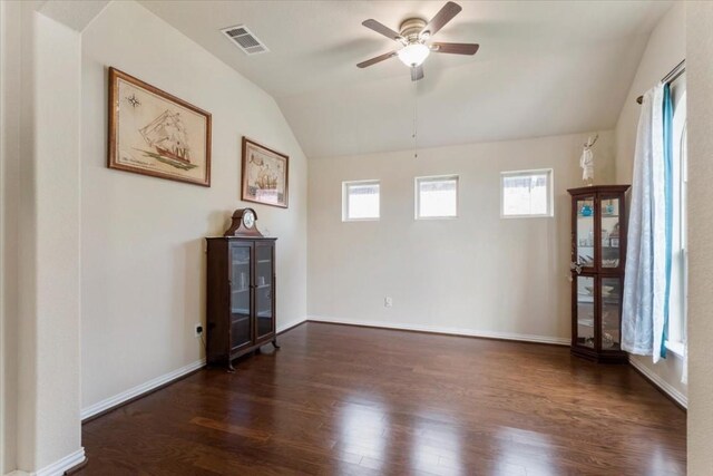 unfurnished room with ceiling fan, vaulted ceiling, and dark hardwood / wood-style floors