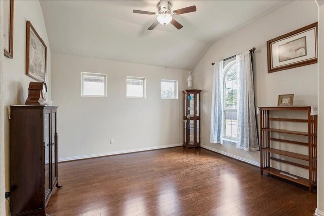 interior space with ceiling fan, dark hardwood / wood-style floors, and lofted ceiling