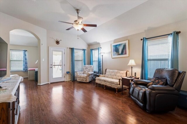 living room featuring ceiling fan, vaulted ceiling, and dark hardwood / wood-style floors