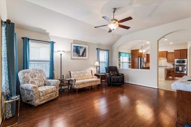 living room featuring ceiling fan, vaulted ceiling, plenty of natural light, and hardwood / wood-style floors