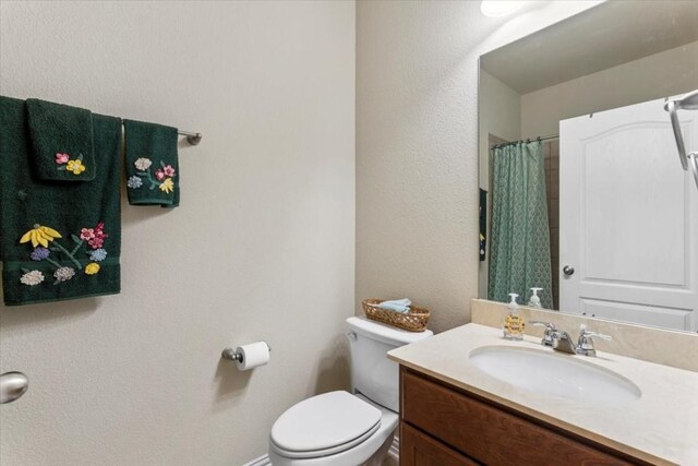 bathroom featuring toilet and vanity