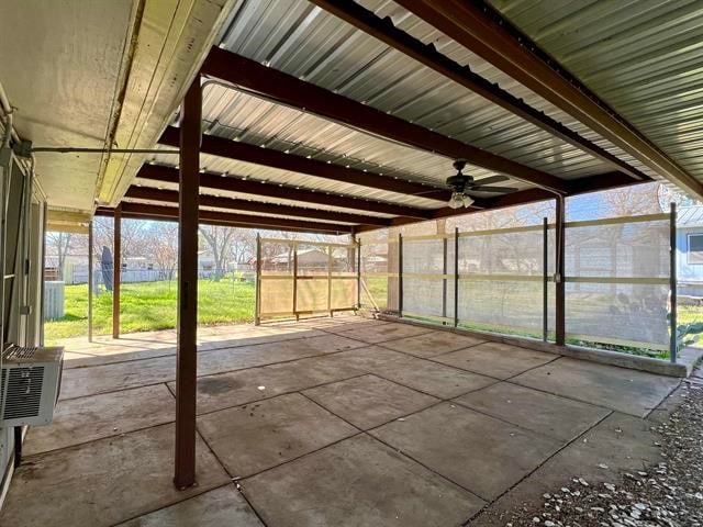 unfurnished sunroom featuring ceiling fan