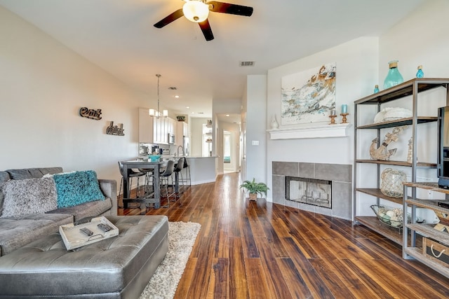 2918 Ranch Road 620 N Unit S-242, Austin, TX 78734 - living room featuring visible vents, a tiled fireplace, wood finished floors, ceiling fan with notable chandelier, and recessed lighting