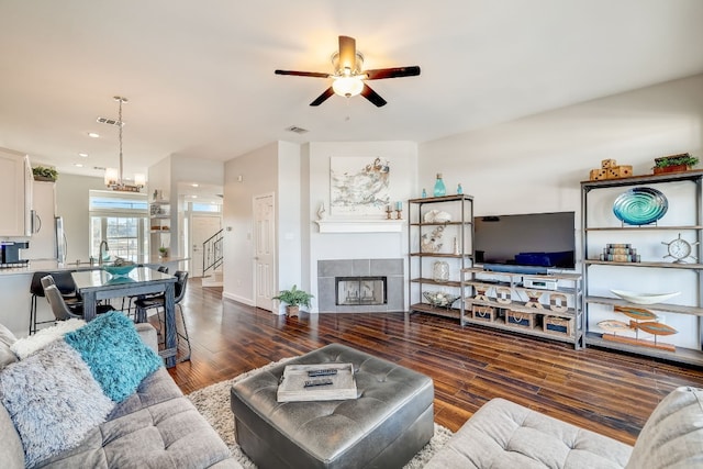 2918 Ranch Road 620 N Unit S-242, Austin, TX 78734 - living area featuring a ceiling fan, visible vents, a tile fireplace, wood finished floors, and stairs