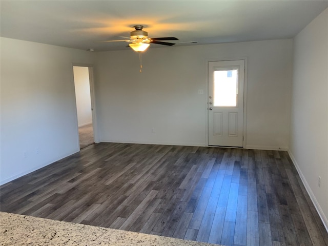 unfurnished room featuring dark hardwood / wood-style floors and ceiling fan