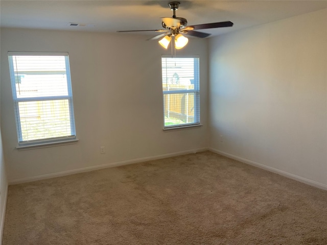 unfurnished room with ceiling fan and carpet floors