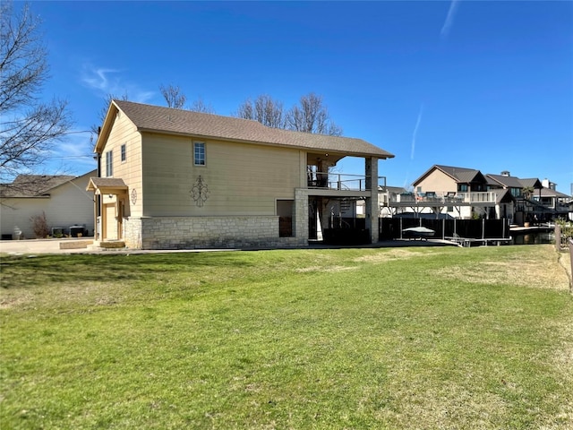 back of property featuring a yard