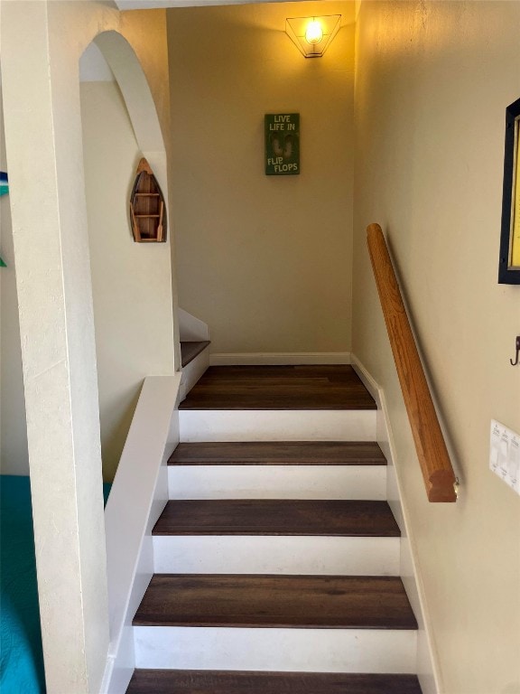 stairway with hardwood / wood-style flooring