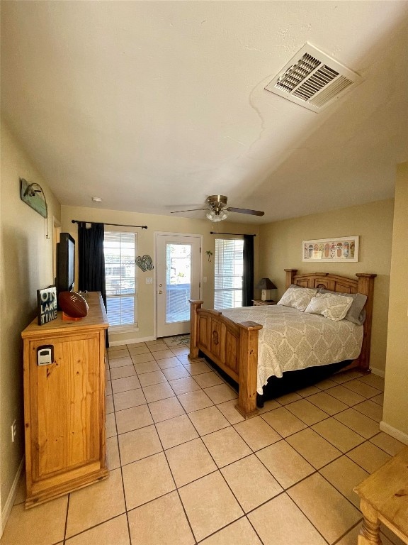 bedroom with access to outside, multiple windows, ceiling fan, and light tile patterned flooring