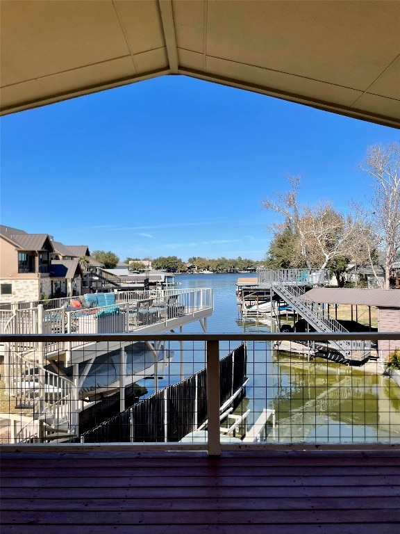 dock area with a balcony and a water view