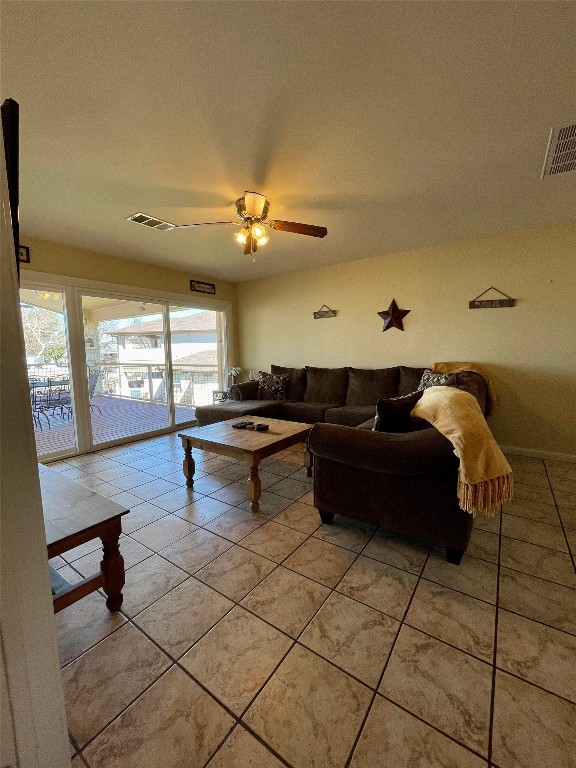 living room featuring light tile patterned floors and ceiling fan