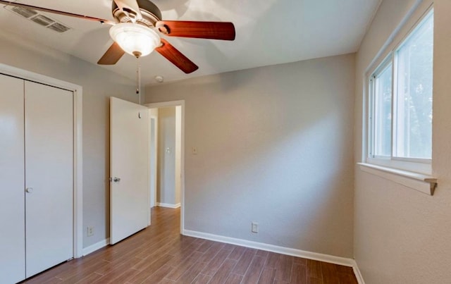 unfurnished bedroom featuring a closet, ceiling fan, and light wood-type flooring