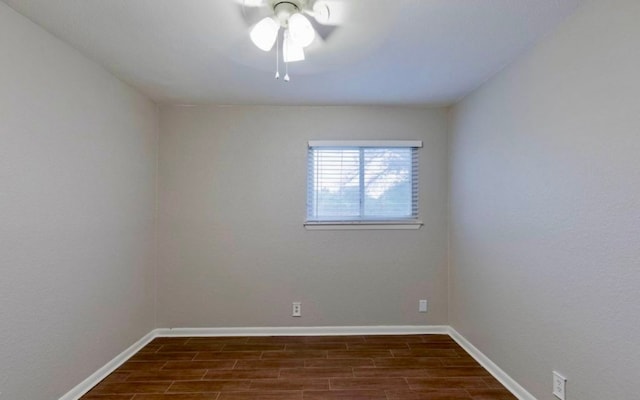 spare room featuring ceiling fan and dark hardwood / wood-style flooring