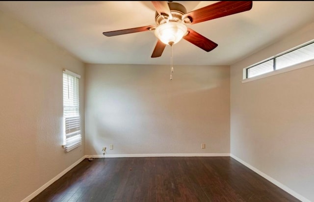 spare room with dark hardwood / wood-style floors and ceiling fan