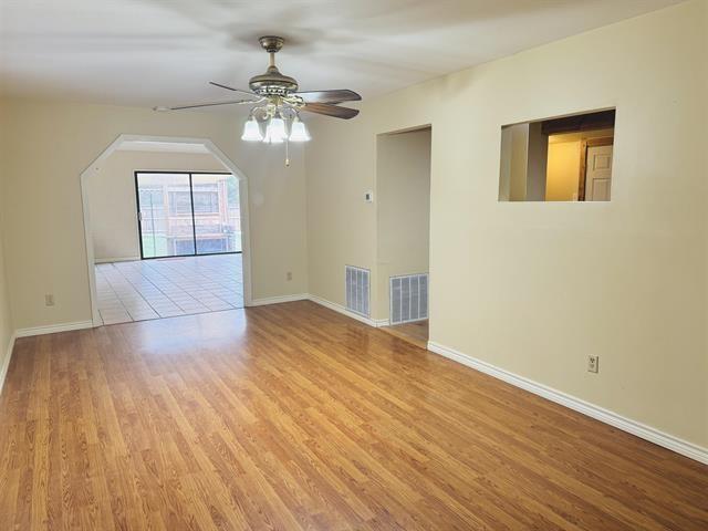 spare room with ceiling fan and light hardwood / wood-style floors