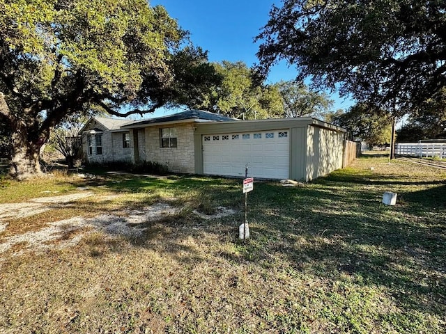 view of side of home with a yard and a garage