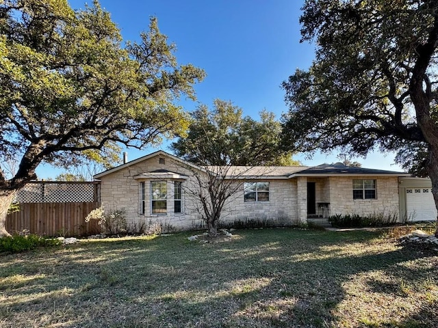 view of front facade featuring a front yard and a garage