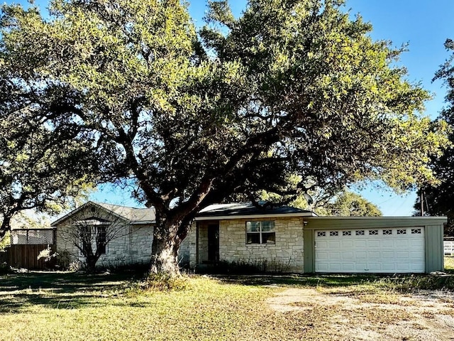 single story home with a front yard and a garage