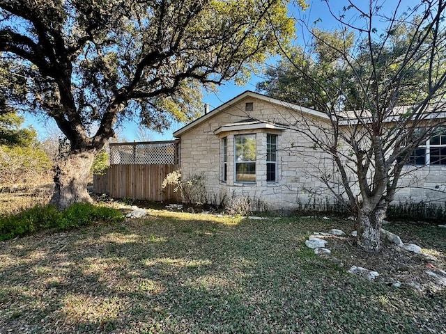 view of home's exterior with a lawn