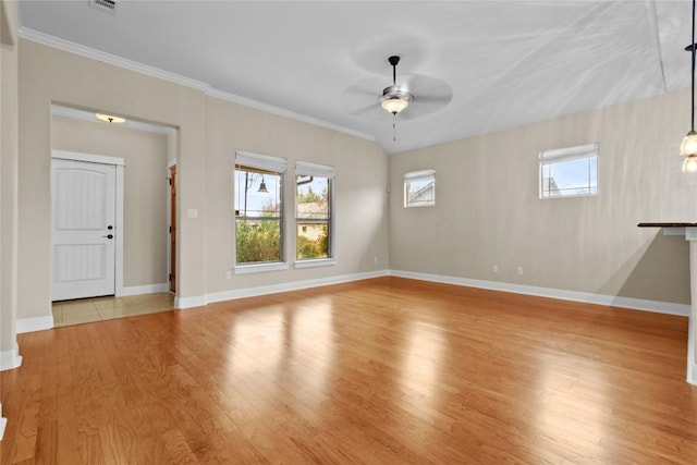 unfurnished living room featuring crown molding, plenty of natural light, light hardwood / wood-style floors, and ceiling fan