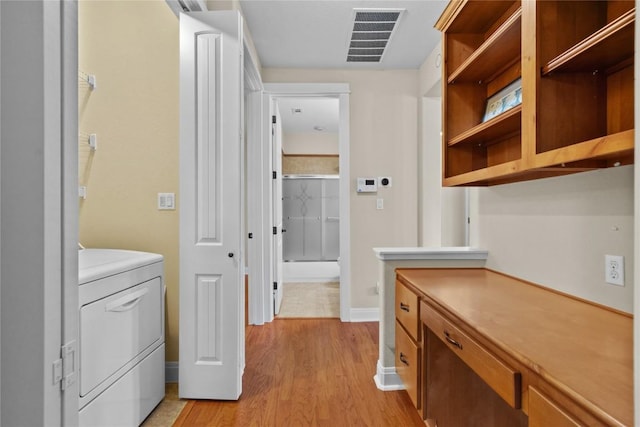 laundry room featuring washer / clothes dryer and light wood-type flooring