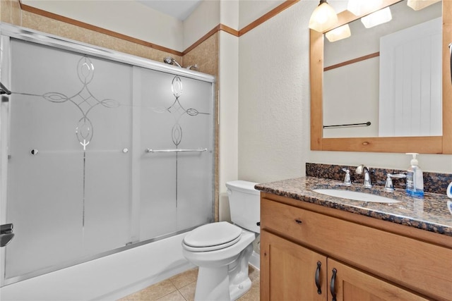 full bathroom with enclosed tub / shower combo, tile patterned floors, toilet, and vanity