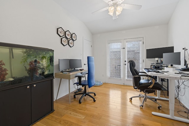 office area featuring ceiling fan, light wood-type flooring, and vaulted ceiling