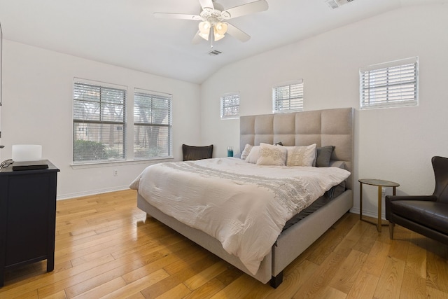 bedroom featuring lofted ceiling, ceiling fan, and light wood-type flooring