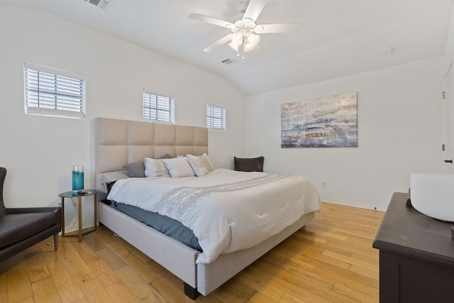 bedroom featuring ceiling fan, lofted ceiling, and light hardwood / wood-style flooring