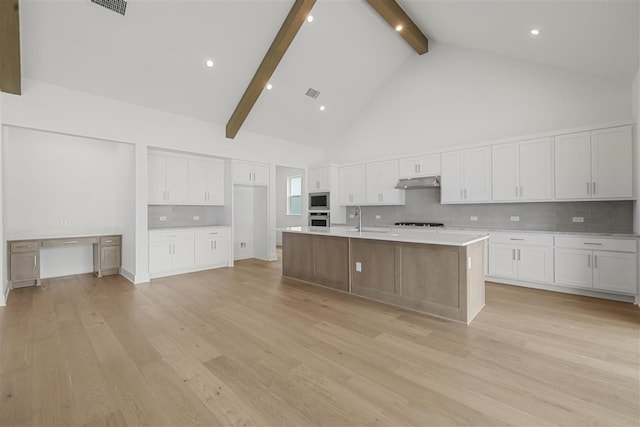 kitchen with white cabinets, tasteful backsplash, high vaulted ceiling, beam ceiling, and a spacious island