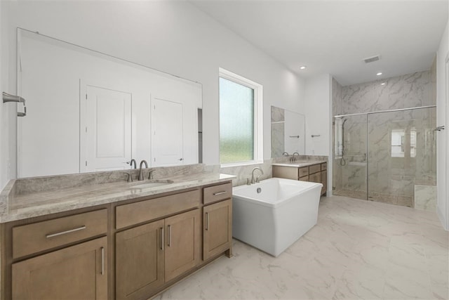 bathroom featuring vanity and shower with separate bathtub