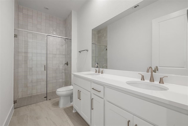 bathroom with walk in shower, vanity, and toilet