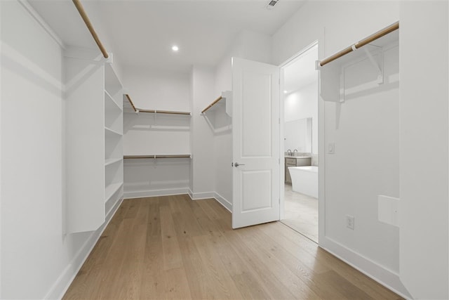 walk in closet featuring light hardwood / wood-style floors