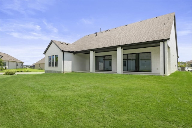 rear view of house with a lawn