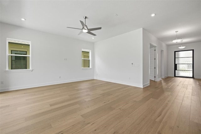 empty room with light hardwood / wood-style floors and ceiling fan