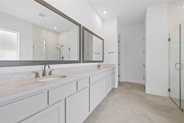 bathroom featuring walk in shower, vanity, and tile patterned floors