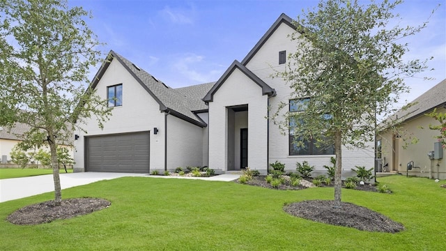 modern inspired farmhouse featuring a front lawn and a garage