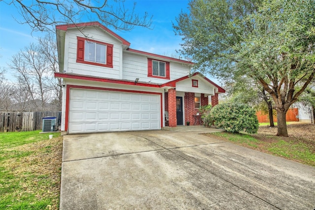 view of property featuring a garage, a front lawn, and central AC unit