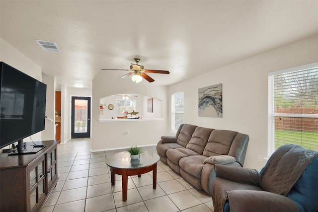 tiled living room with ceiling fan