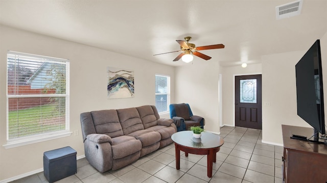 tiled living room with ceiling fan and a healthy amount of sunlight