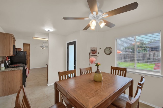 dining area featuring light tile patterned flooring and ceiling fan