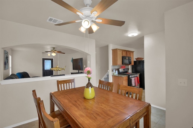 tiled dining area with ceiling fan